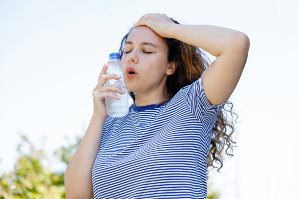 istock Young woman having hot flash and sweating in a warm summer day 2176371171
