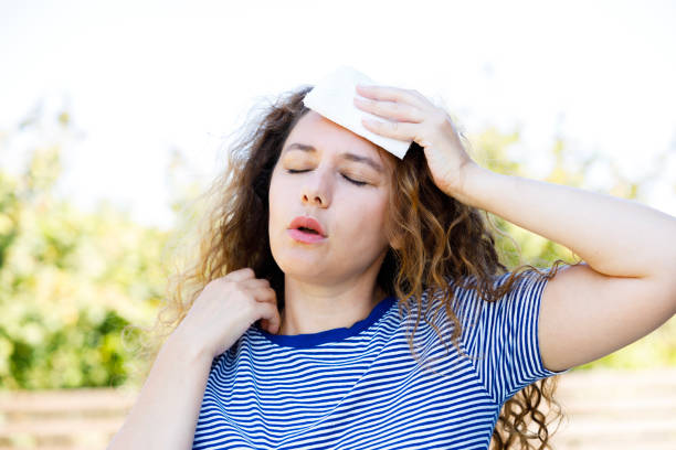 istock Young woman having hot flash and sweating in a warm summer day 2176372707