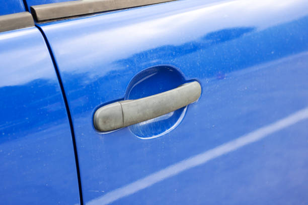 istock Door handle on a blue car closeup 2176372990
