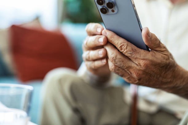 istock Home, senior man on sofa and smartphone with typing, internet and message for contact, texting and relax. Mature person, apartment and elderly guy on couch, cellphone and mobile user with network. 2176373461