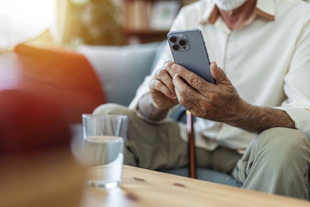 istock Home, senior man on sofa and smartphone with typing, internet and message for contact, texting and relax. Mature person, apartment and elderly guy on couch, cellphone and mobile user with network. 2176373561