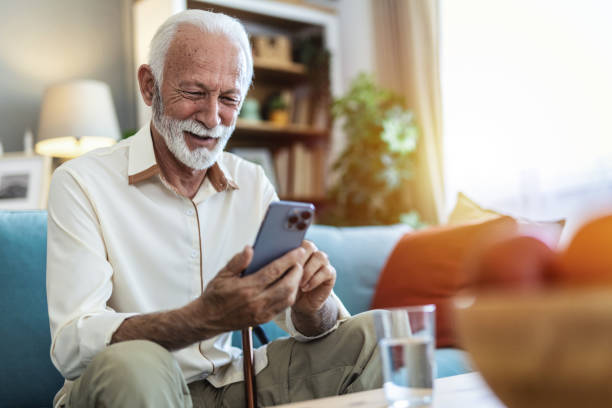 istock Home, senior man on sofa and smartphone with typing, internet and message for contact, texting and relax. Mature person, apartment and elderly guy on couch, cellphone and mobile user with network. 2176373629