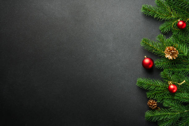 istock Christmas flat lay background with fir tree and holiday decorations on black. 2176374632
