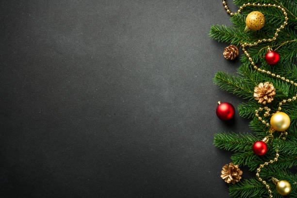 istock Black Christmas flat lay background with fir tree and holiday decorations. 2176374672