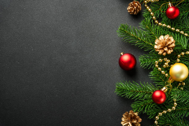 istock Black Christmas flat lay background with fir tree and holiday decorations. 2176374677