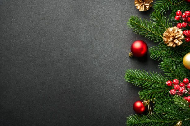 istock Black Christmas flat lay background with fir tree and holiday decorations. 2176374705