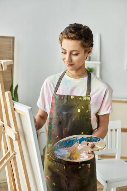 istock A young woman immersed in her creative process in a bright home art studio 2176375064