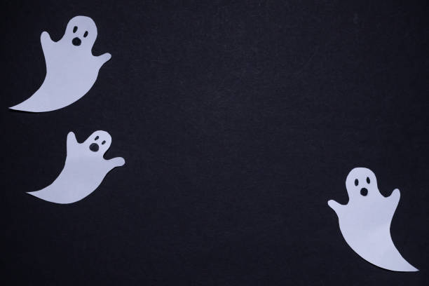 Three ghosts on black background. Halloween holiday. For backgrounds and presentations