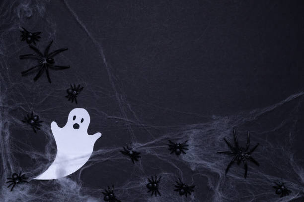 istock Ghosts shrouded in spider webs with spiders on black background. Halloween holiday. For backgrounds and presentations 2176376347