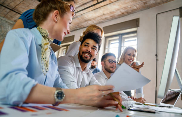 istock Group of young multi-ethnic startup business team collaborating on project in modern office 2176378599