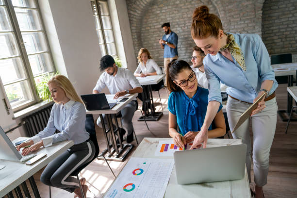 istock Group of young multi-ethnic startup business team collaborating on project in modern office 2176378729