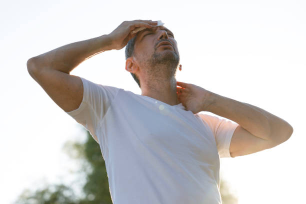 istock Young man having hot flash and sweating in a warm summer day 2176379268