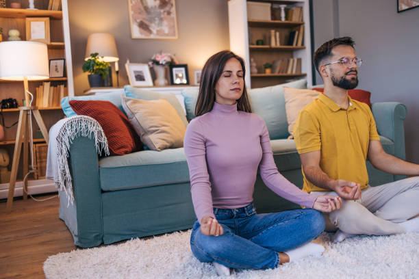 istock Adult couple practicing yoga at home 2176381259