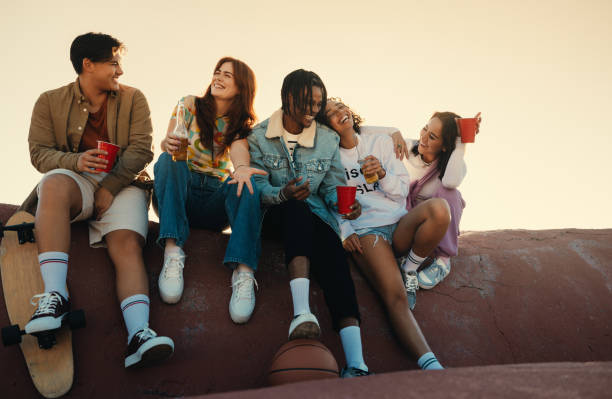 istock Group of friends hanging out and chatting outdoors with drinks 2176381301