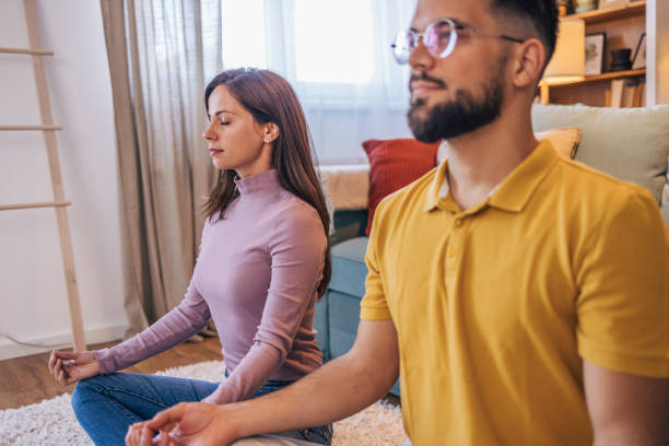 istock Adult couple practicing yoga at home 2176381462