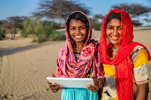 istock Happy Gypsy Indian girls using digital tablet, India 2176381567