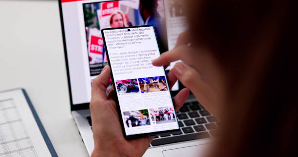 istock Watching Online News Article On Mobile Phone 2176382722