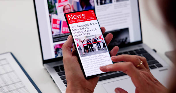istock Watching Online News Article On Mobile Phone 2176382749