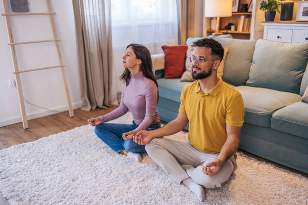istock Adult couple practicing yoga at home 2176383400