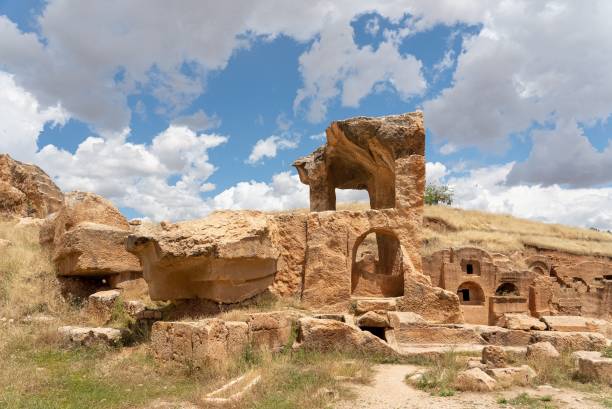 istock Ancient rock-cut tombs and ruins under a partly cloudy sky 2176383803