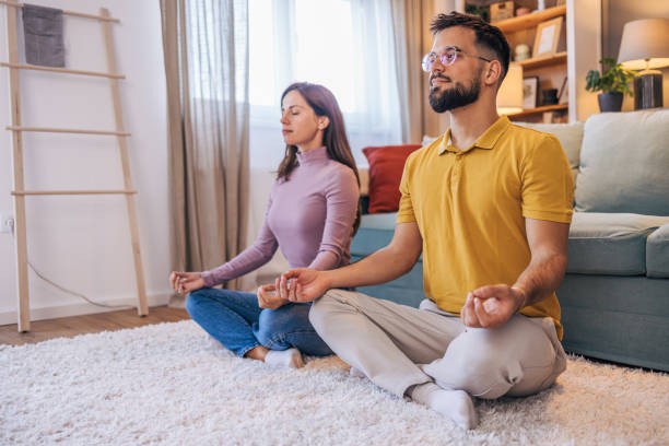 istock Adult couple practicing yoga at home 2176383987