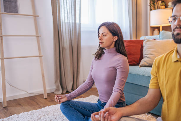 istock Adult couple practicing yoga at home 2176383991