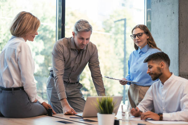 istock Group of happy progressive business people working on startup together at creative office 2176389948