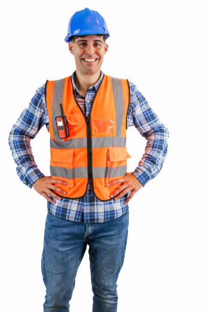 istock vertical Construction worker with hands on hips wearing orange vest and safety helmet 2176391509