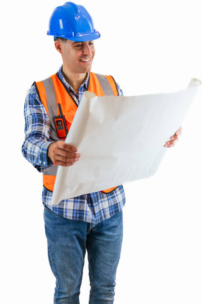 istock vertical Construction worker examining a project blueprint wearing orange vest and safety helmet 2176391574