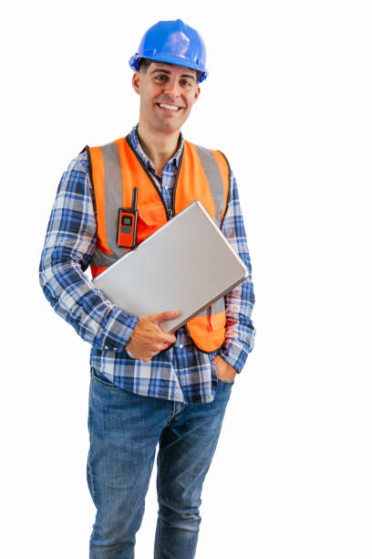 istock vertical Engineer holding his laptop while looking at camera wearing orange vest and safety helmet 2176391777