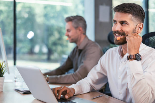 istock Young handsome male customer support phone operator with headset working in call center. 2176392401