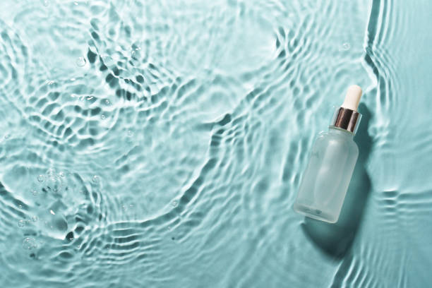 istock Serum bottle in the water on blue. 2176392596