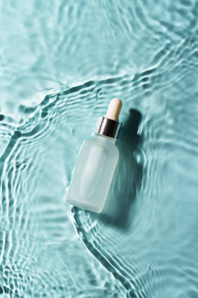 istock Serum bottle in the water on blue. 2176392613
