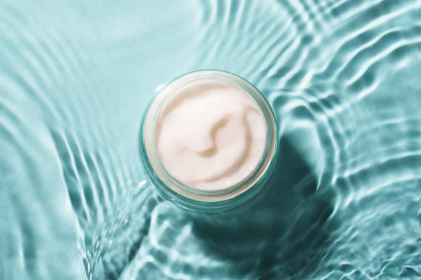 istock Cream jar in the water on blue background. 2176392634