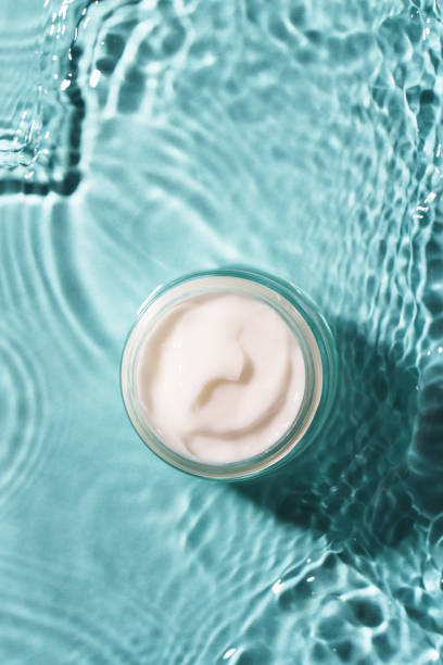 istock Cream jar in the water on blue background. 2176393489