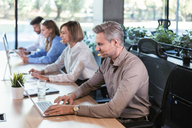 istock Happy young male customer support executive working in office. 2176395162