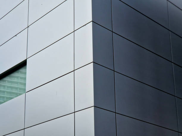 istock cladding of a building with a expanded metal lattice structure. galvanized gray nets protect the industrial building. Blue sky in contrast to a silver background, wall, corner, slanted, sheet metal 2176396174
