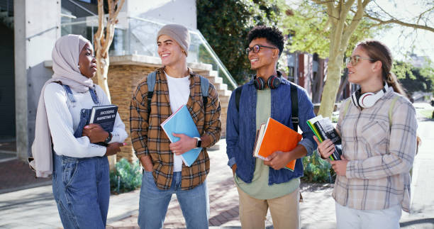 istock Diversity, learning and friends with people and books for future, education and knowledge. University, academy and youth development with students at college campus for scholarship, school and study 2176396470