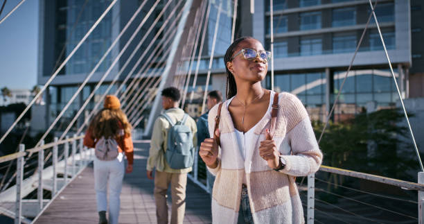 Student, education and thinking with woman and walking for learning, future and knowledge. University, inspiration and youth development with person at college for scholarship, vision and studying