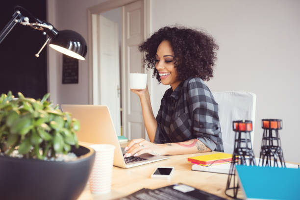 istock Afro young woman in the home office, using laptop 2176398235