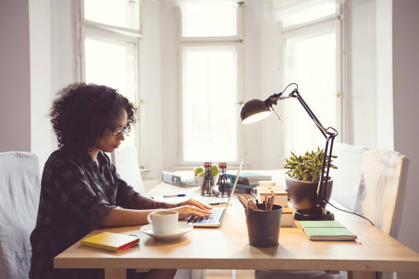 istock Afro young woman in the home office, using laptop 2176398254