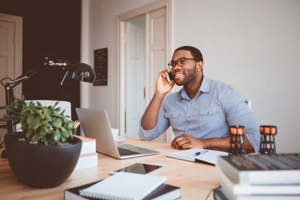 istock Young businessman at home office talking on phone 2176398543