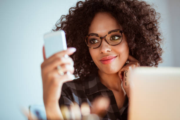 istock Young woman with eyeglasses using mobile phone 2176398778