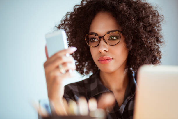 istock Young woman with eyeglasses using mobile phone 2176398796
