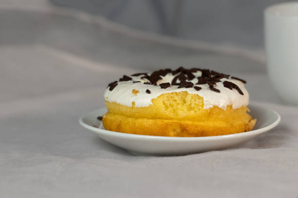 A pastry coated with milk and topped with nuts.