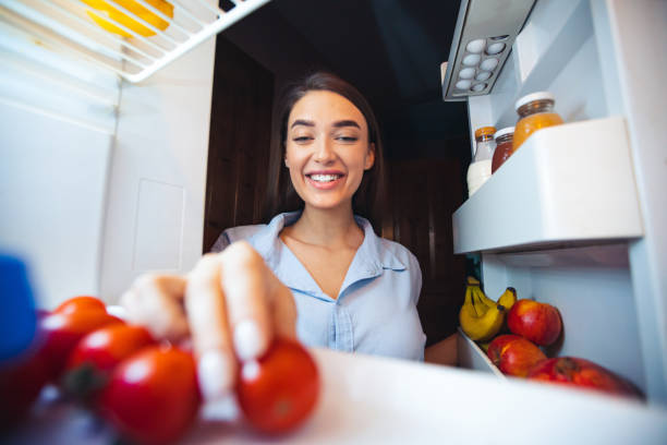 istock Young woman taking fresh healthy vegetables from fridge 2176399838