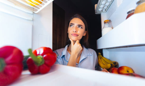 istock Thoughtful housewife looking into fridge, view from inside 2176399888