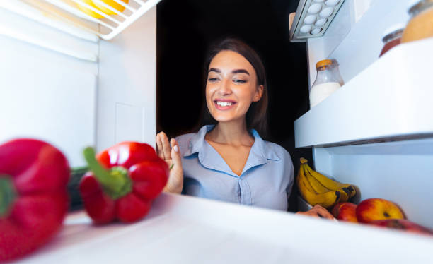 istock Happy woman taking fresh vegetables from fridge 2176399892