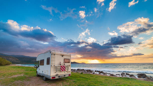 istock Coastal sunset with recreational vehicle, Motorhome parked by the seaside under a dramatic sunset sky 2176403779