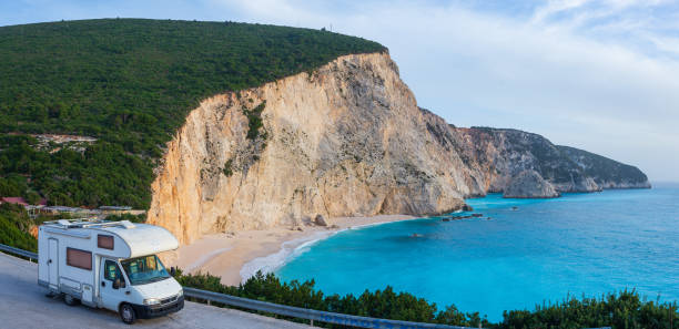 istock Serene seaside rv camping experience, Motorhome parked by a tranquil coastal inlet under a clear blue sky. Lefkada, Greece. 2176403789